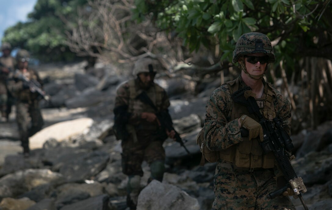 Cpl. Cory P. Sargent leads a patrol down along the beach after inserting via combat rubber raiding craft, July 27, 2016, during a multi-national, bilateral exercise, on Motutapu Island, Tonga, between U.S. and Tongan Force, designed to increase relations and interoperability. The service members combined skills learned during the exercise such as buddy rushes, high explosive exploitation, demolition and beach insertion during the culminating range. Sargent, from Hillsboro, Oregon, is an infantryman with Task Force Koa Moana and is originally assigned to Company A, 1st Battalion, 1st Marine Regiment, 1st Marine Division, I Marine Expeditionary Force. (U.S. Marine Corps photo by Cpl. William Hester/ Released)