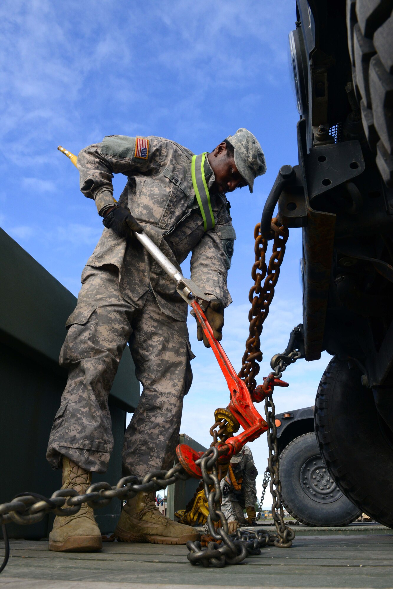 Spc. Keon Hill, a transportation operator with the 539th Composite Truck Company from Fort Wainwright, Alaska, uses a load binder to secure a Humvee on a M915A5 Line-Haul Tractor Truck, in support of Polar Express at Joint Base Elmendorf-Richardson, Alaska, August 3, 2016. The equipment transported will be used by U.S. Army Alaska Soldiers assigned to the 2nd Battalion, 377th Parachute Field Artillery Regimen; 1st Battalion, 501st Parachute Infantry Regiment; 3rd Battalion, 509th Parachute Infantry Regiment; and 1st Squadron (Airborne), 40th Cavalry Regiment will execute a live-fire training exercise with 105-mm howitzers, 60-mm, 81-mm, and 120-mm mortars at The DonnelyTraining Area. The exercise will ensure proficiency and increase capabilities, as well as ensure certification in support of future operations. (U.S Air Force photo by Airman 1st Class Javier Alvarez)