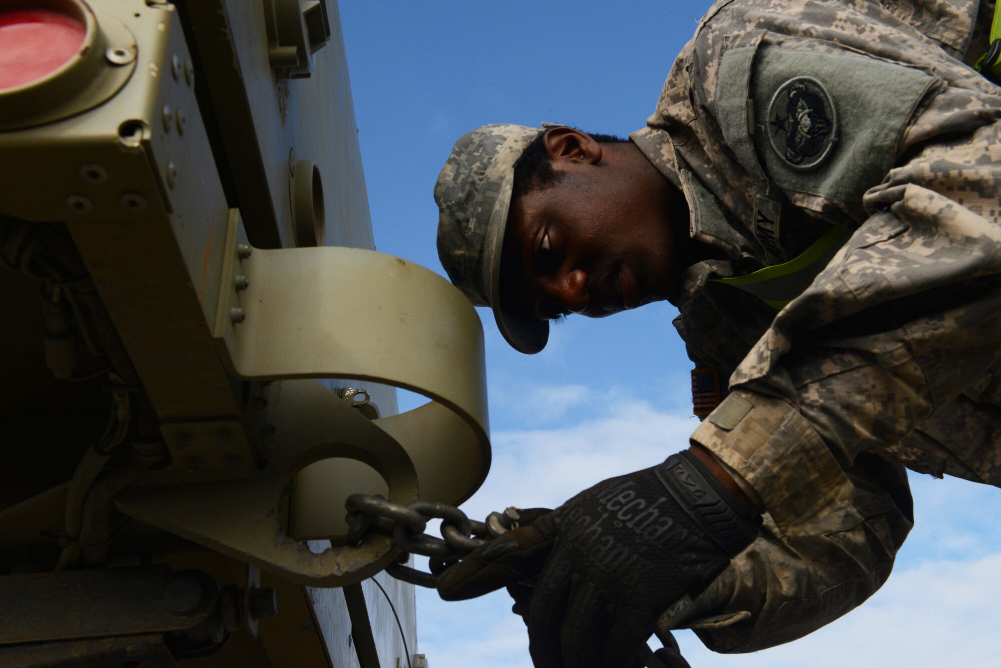 Spc. Keon Hill, a transportation operator with the 539th Transportation Company from Fort Wainwright, Alaska, secures a vehicle on the back of an M915A5 Line-Haul Tractor Truck, in support of Polar Express at Joint Base Elmendorf-Richardson, Alaska, August 3, 2016. The equipment transported will be used by U.S. Army Alaska Soldiers from multiple units for a live fire training exercise at The Donnely Training Area. (U.S Air Force photo by Airman 1st Class Javier Alvarez)