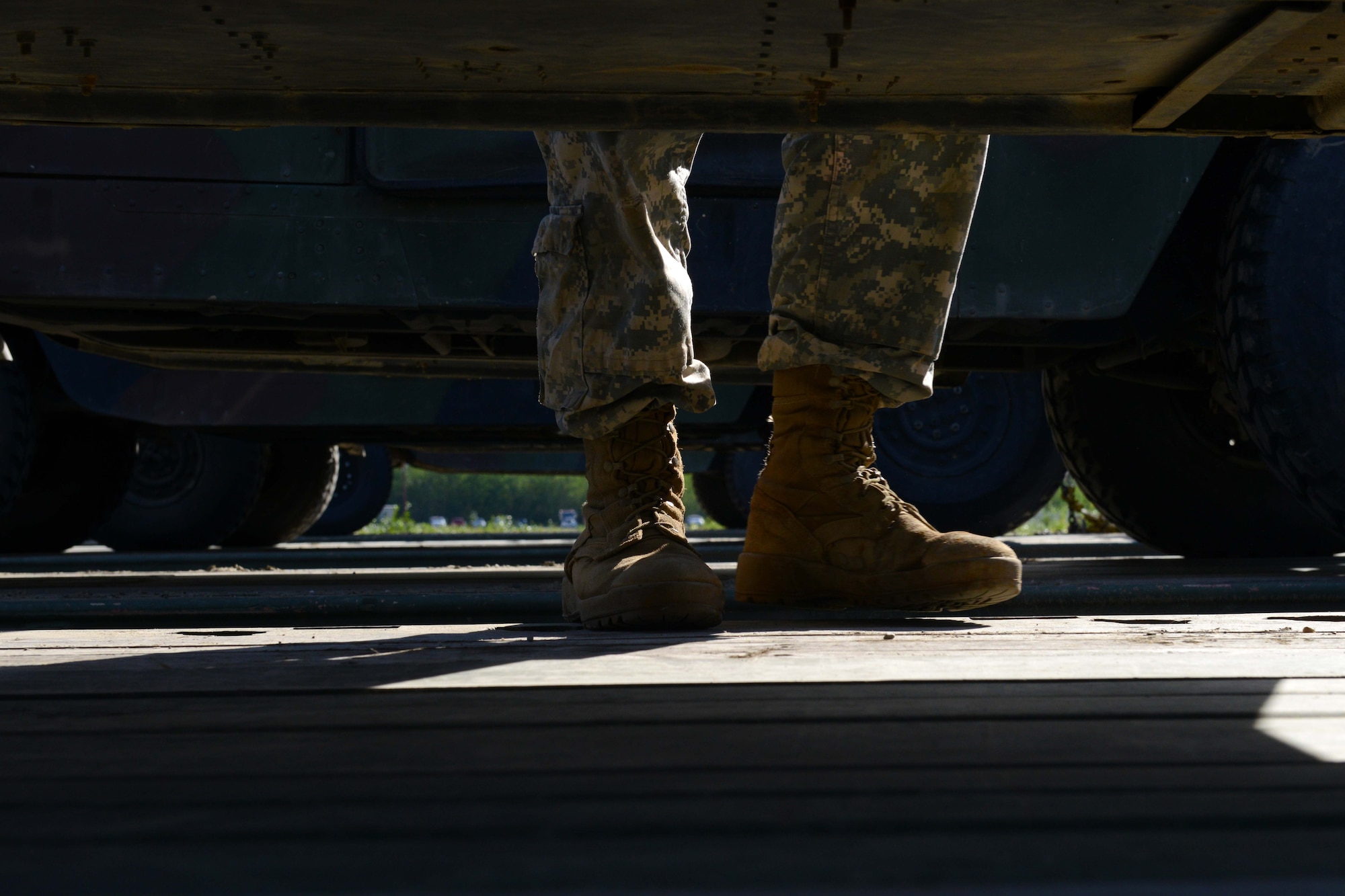 A U.S. Army Soldier with the 539th Composite Truck Company from Fort Wainwright, Alaska, shuffles across an M915A5 Line-Haul Tractor Truck at Joint Base Elmendorf-Richardson, Alaska, August 3, 2016. The M915A5’s main role is to transport containers, bulk supplies, water and fuel from the ocean ports to division support areas within the theater of operation. (U.S Air Force photo by Airman 1st Class Javier Alvarez)