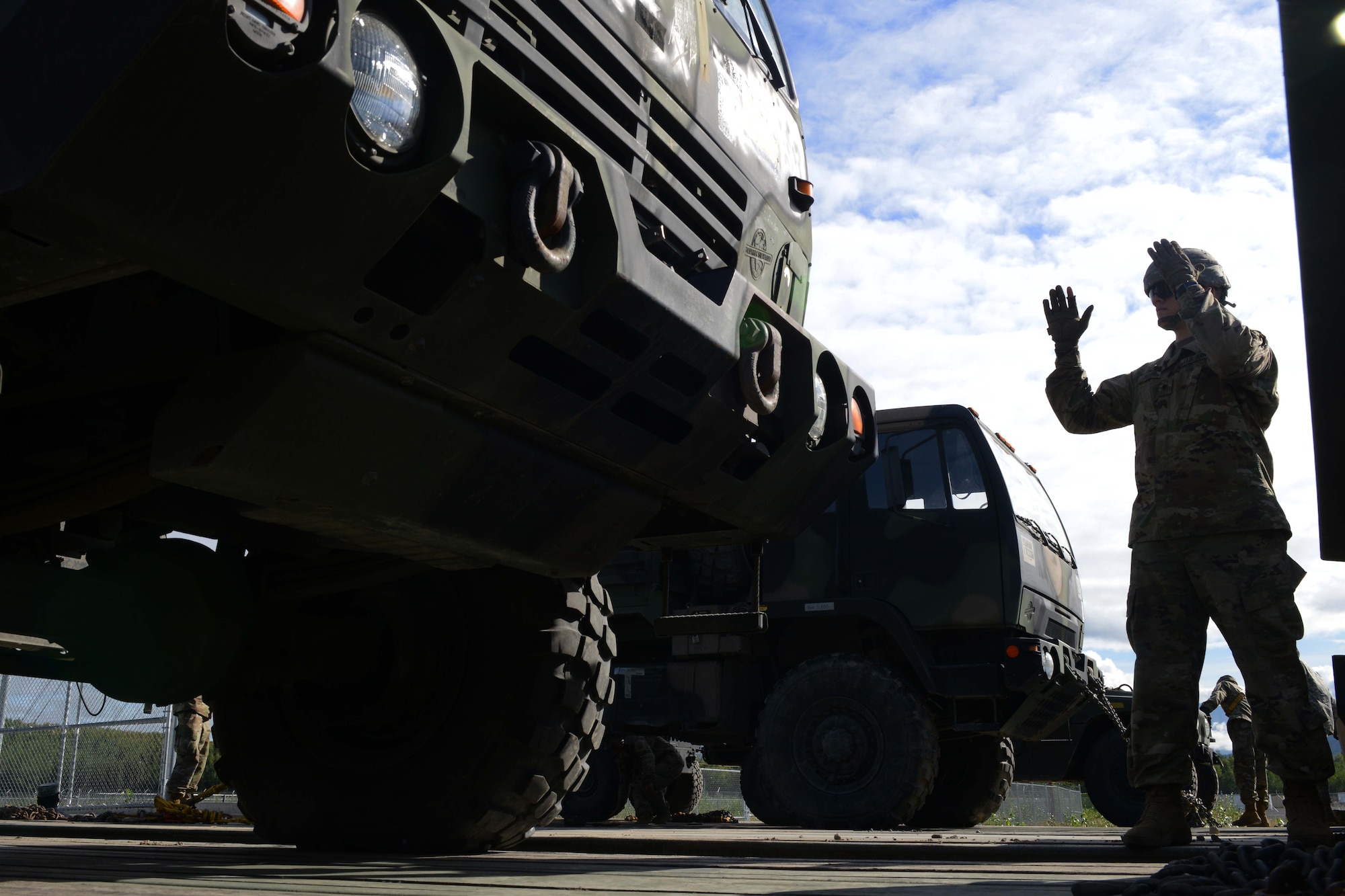A U.S. Army Soldier with the 539th Composite Truck Company from Fort Wainwright, Alaska, directs Spc. Adam Wells, a heavy transportation operator with the 539th CTC, as he drives onto an M915A5 Line-Haul Tractor Truck at Joint Base Elmendorf-Richardson, Alaska, August 3, 2016. The M915A5 can travel 600 miles on its internal 120-gallon fuel tanks. U.S. Air Force photo by Airman 1st Class Javier Alvarez)