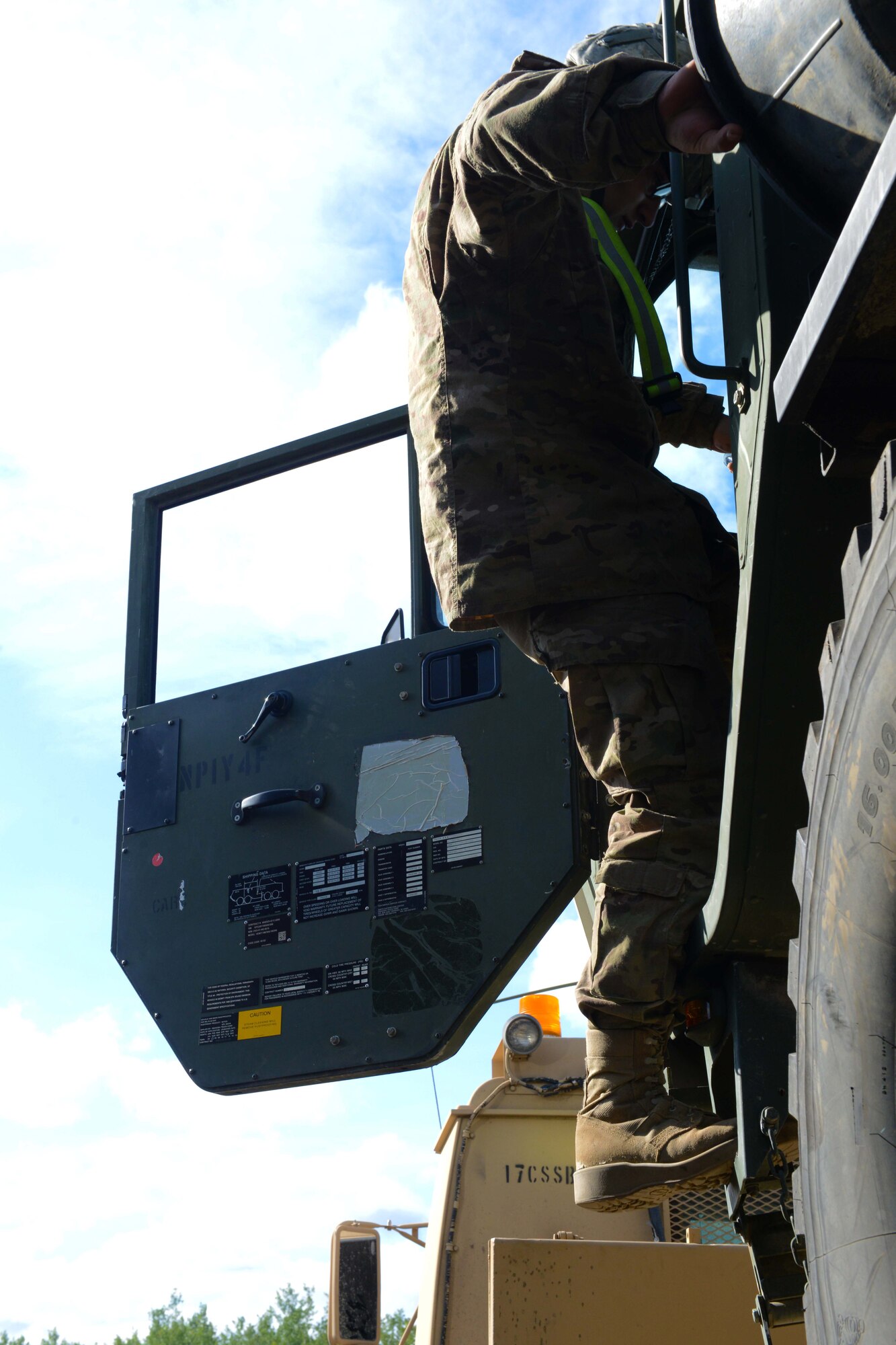 Spc. Adam Wells, a heavy transportation operator with the 539th Composite Truck Company from Fort Wainwright, Alaska, exits a Heavy Expanded Mobility Tactical Truck fuel servicing truck, at Joint Base Elmendorf-Richardson, Alaska, August 3, 2016. The HEMTT first went into service with the US Army in 1985, replacing the M520 Goer trucks. More than 13,000 HEMTTs are in service today. (U.S Air Force photo by Airman 1st Class Javier Alvarez)
