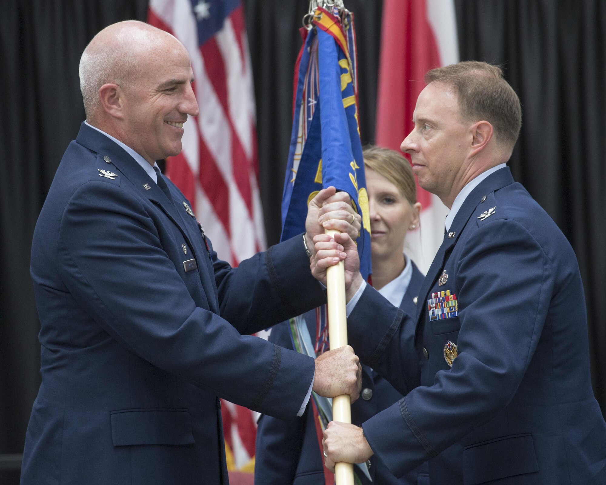 Col. John Winkler, right, incoming 374th Mission Support Group commander, receives the guidon from Col. Kenneth Moss, left, 374th Airlift Wing commander, during a change of command ceremony at Yokota Air Base, Japan, Aug. 8, 2016. Prior to taking command, Winkler was the deputy commander for the 319th Mission Support Group, Grand Forks Air Force Base, North Dakota. The change of command ceremony is a symbolic gesture to officially transfer the responsibility between the outgoing and incoming commander. (U.S. Air Force photo by Yasuo Osakabe/Released) 