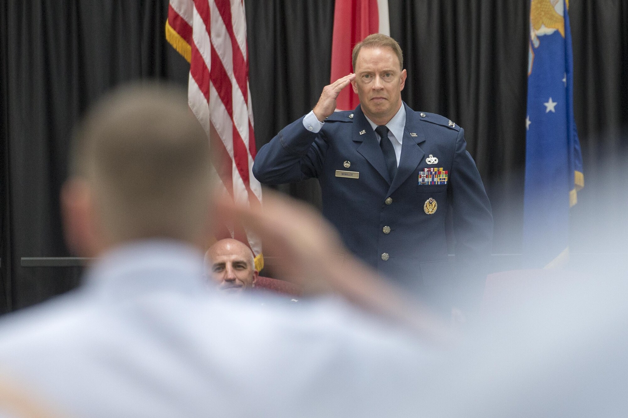 Col. John Winkler, 374th Mission Support Group commander, renders his first salute as commander during a change of command ceremony at Yokota Air Base, Japan, Aug. 8, 2016. (U.S. Air Force photo by Yasuo Osakabe/Released)