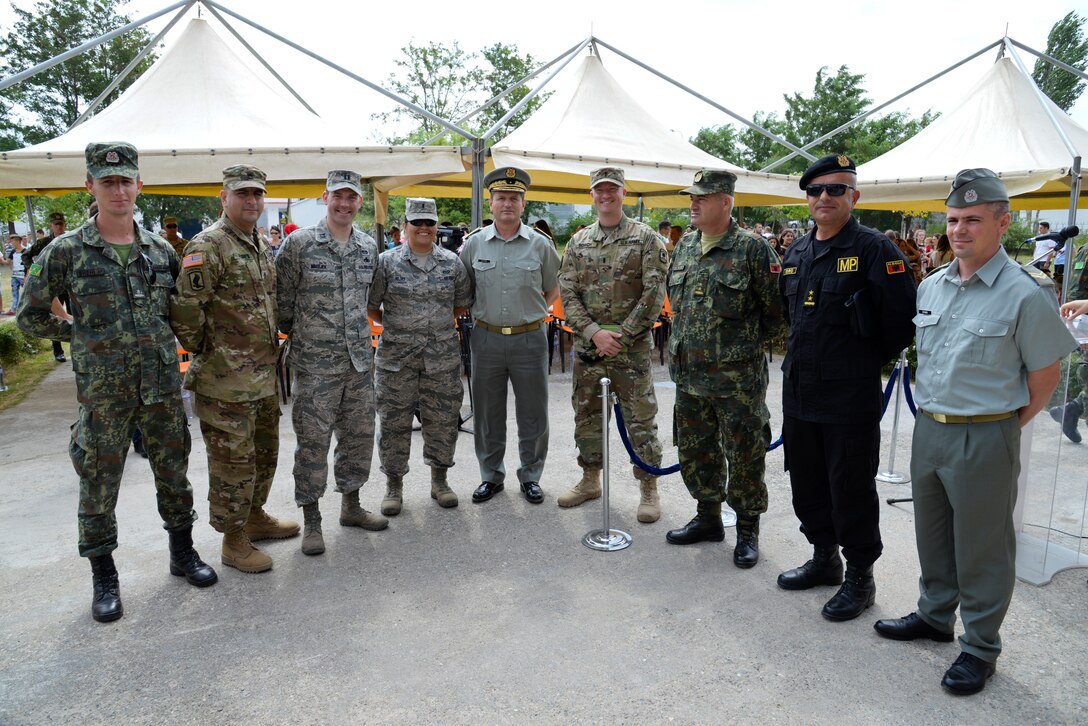 Civil Engineers from the New Jersey Air National Guard, members of the U.S. Army's 457th Civil Affairs Battalion and unit members of the Albanian Army land forces pose for a group photo prior to an inauguration ceremony marking the completion of renovation of the 12 year school in Mjede, Albania on July 15, 2016. The partial renovation of the school was made possible by the European Commands’ Humanitarian Civic Assistance (HCA) program of the United States Department of Defense. The 177th Fighter Wing members were on a two week a deployment for training and teamed up with Albanian Army land forces unit members from the 1st Infantry Battalion in Vau i Dejës, Albania, and worked on plumbing, electrical, ceramic tile, roofing, and door and frame maintenance and installations. New Jersey and Albania are paired under the National Guard's State Partnership Program and are a proven partnership built upon shared values, experiences and vision. (U.S. Air National Guard photo by Master Sgt. Andrew J. Moseley/Released)