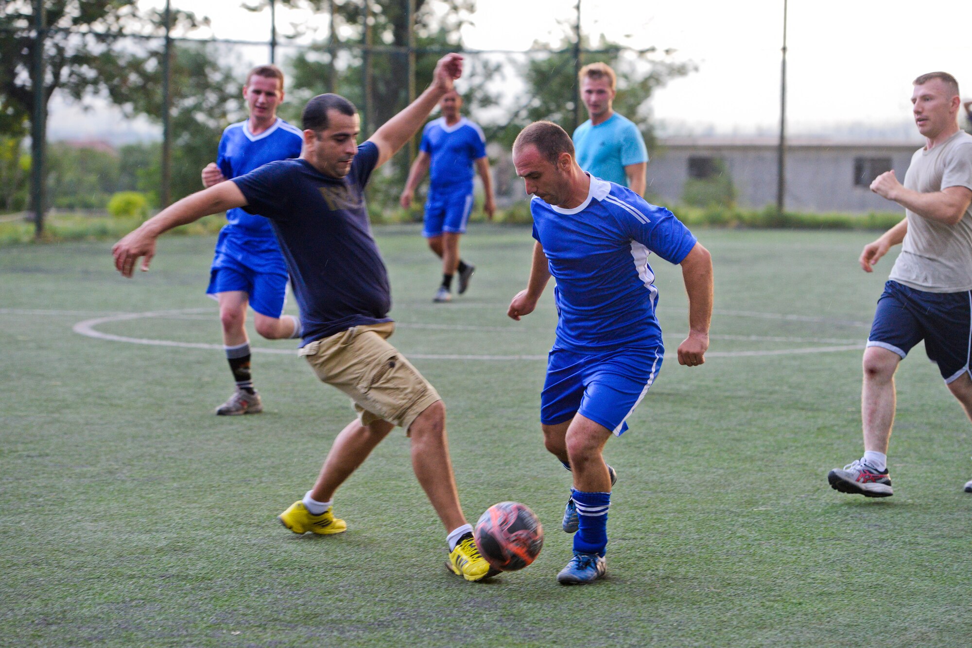 A picture of U.S. Air Force airmen with the New Jersey Air National Guard, U.S. Army soldiers with the 457th Civil Affairs Battalion and members of the 1st Infantry Battalion of the Albanian Land Forces playing soccer.