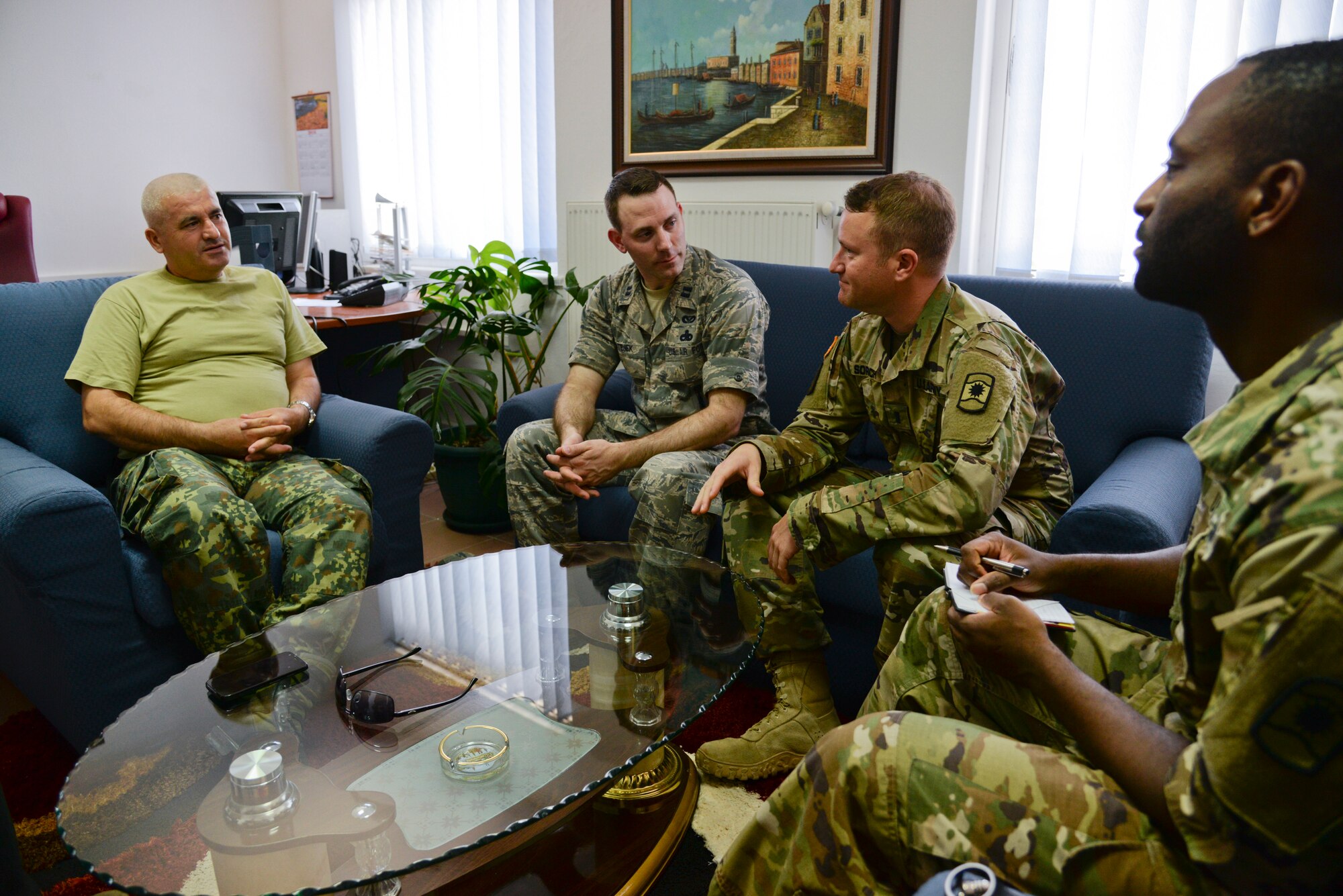 A picture of Albanian Army Lt. Col. Ali Mali, Commander of the 1st Infantry Battalion of the Albanian Land Forces, U.S. Air Force Capt. Andrew Matejek, 177th Fighter Wing Civil Engineer, and U.S. Army 1st Lt. John Sorich and Specialist Donald Patterson, 457th Civil Affairs Battalion discussing Humanitarian and Civic Assistance renovation projects.