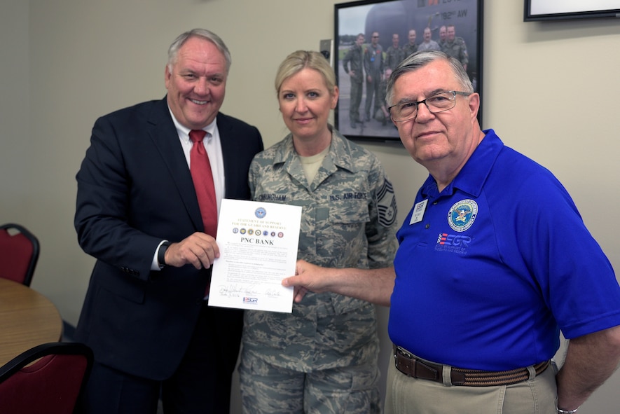Doug Stewart, left, a regional president with PNC Bank, U.S. Air Force Chief Master Sgt. Kelly Cunningham, center, a superintendent with the 183rd Air Operations Group, and Ron Bacci, the chair of the Illinois Employer Support of the Guard and Reserve field committee, pose after signing a pledge of support during an ESGR “Breakfast with the Boss” event at the 182nd Airlift Wing, Peoria, Ill., June 8, 2016. Stewart and civilian employers toured the base to see firsthand how their employees serve the Illinois National Guard. (U.S. Air National Guard photo by Staff Sgt. Lealan Buehrer)