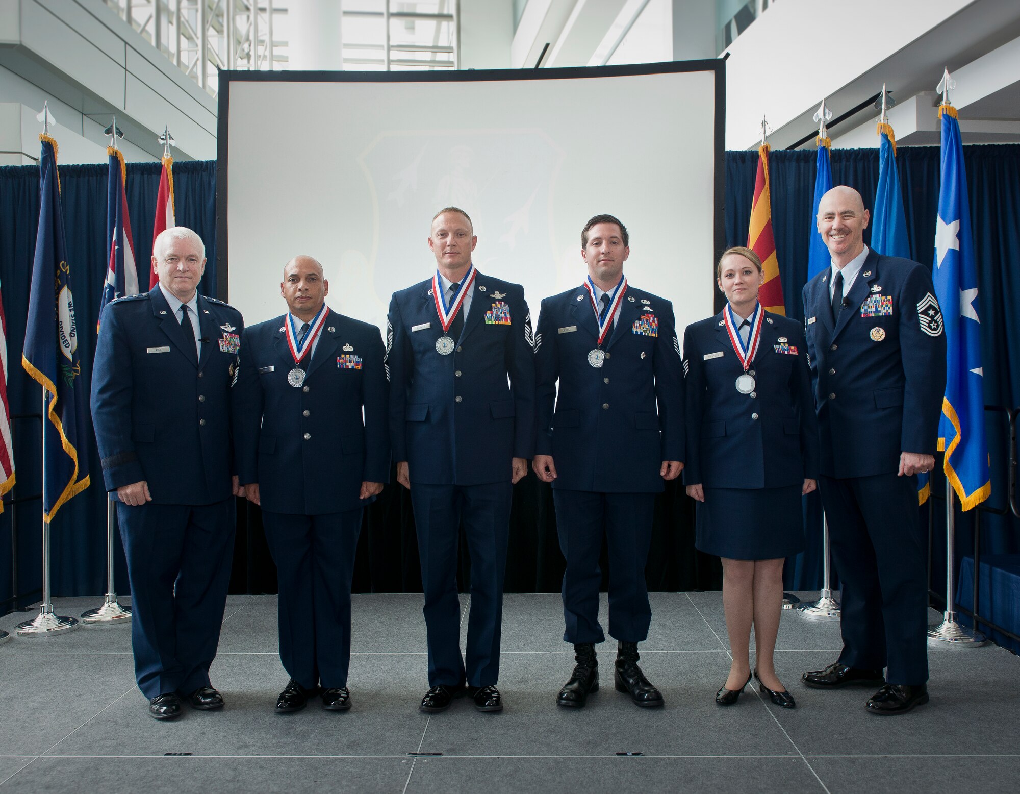 Lt. General L. Scott Rice, director of the Air National Guard and Chief Master Sgt. Ronald C. Anderson, the command chief master sergeant of the ANG, pose for a photo with the ANG Outstanding Airmen of the Year during the Focus on the Force Week All Call. The OAY winners are Staff Sgt. Jennifer Masters, Airman of the Year; Tech. Sgt. Nicholas Jewell, Non-Commissioned Officer of the Year; Senior Master Sgt. Mark Farmer, Senior Non-Commissioned Officer of the Year; and Senior Master Sgt. Jack Minaya, First Sergeant of the Year. (U.S. Air National Guard photo by Master Sgt. Marvin R. Preston)