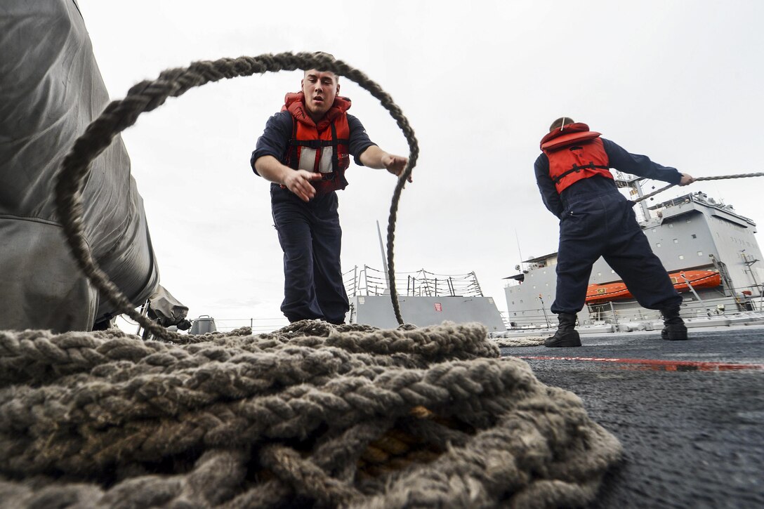 Navy Petty Officer 2nd Class James Callison coils a line aboard the guided-missile destroyer USS Momsen during a replenishment with the fleet replenishment oiler USNS Joshua Humphreys in the South China Sea, Aug. 8, 2016. The Momsen is supporting maritime security and stability in the Indo-Asia Pacific region as part of a U.S. 3rd Fleet Pacific Surface Action Group. Callison is a gunner's mate. Navy photo by Petty Officer 1st Class Jay Pugh