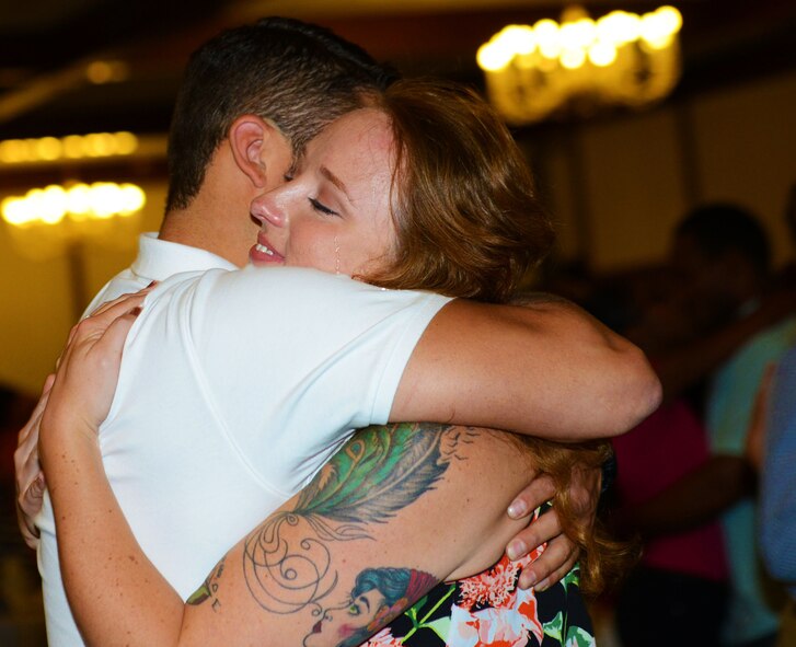 Staff Sgt. Joy Martz, 603rd Air Operations Center NCO in charge of command post training, embraces her fiancé, Staff Sgt. Joe Ferrara, 721st Aerial Port Squadron air transportation specialist, at the end of a marriage seminar at Ramstein Air Base, Germany, Aug. 6, 2016. Gary Chapman, marriage counselor and author of “The 5 Love Languages” book series, spoke to Kaiserslautern Military Community couples on how to enrich their life with their spouses. (U.S. Air Force photo/ Airman 1st Class Joshua Magbanua)
