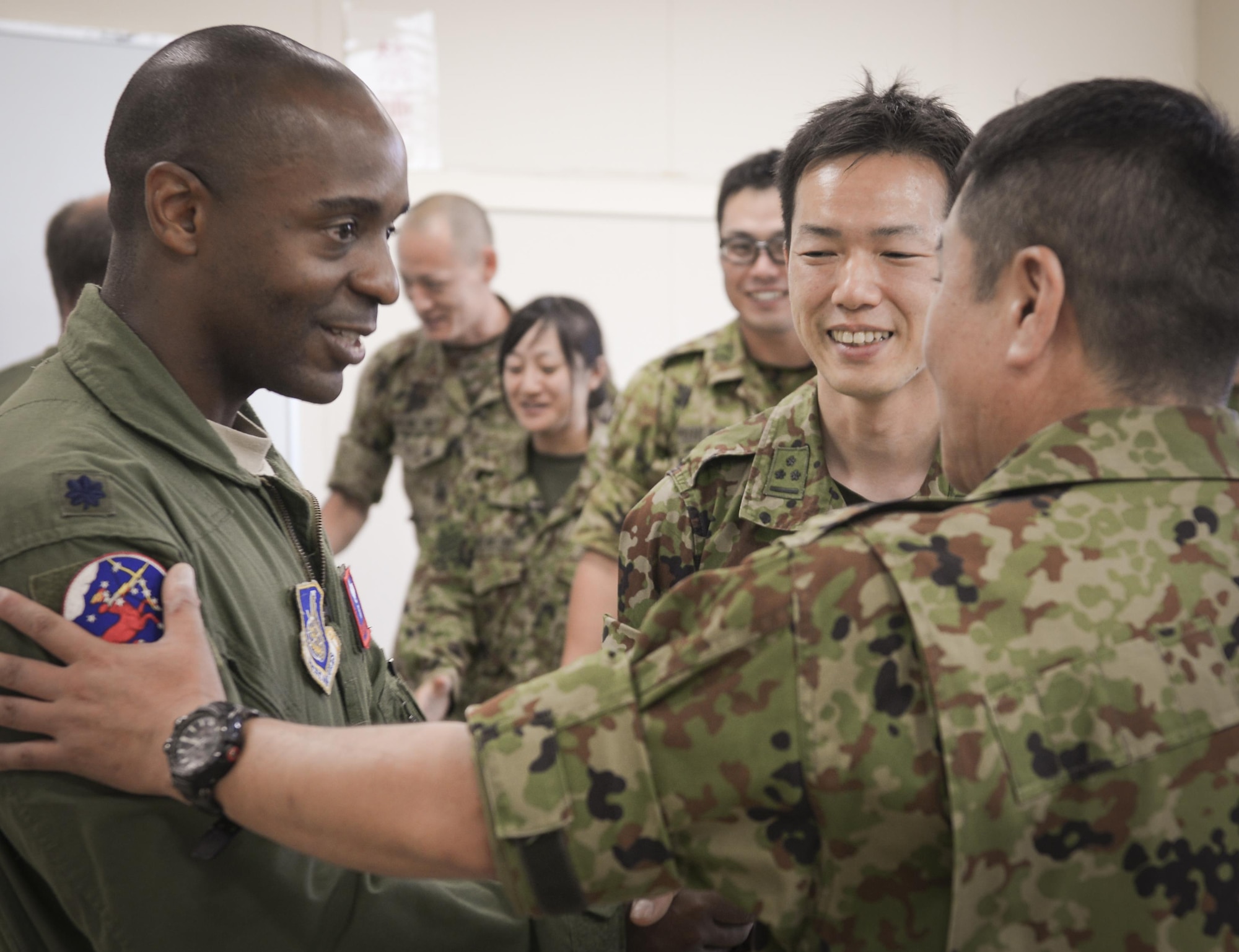 Lt. Col. Trenton Alexander, 459th Airlift Squadron director of operations, speaks with members of the Japan Ground Self-Defense Force at Camp Tachikawa, July 26, 2016. Members of the JGSDF invited the 459th Airlift Squadron to attend the 2nd Tachikawa Helicopter Conference as friends and allies. U.S. forces have supported Japan in disaster-relief efforts for more than 70 years.  (U.S. Air Force photo by Airman 1st Class Elizabeth Baker/Released)