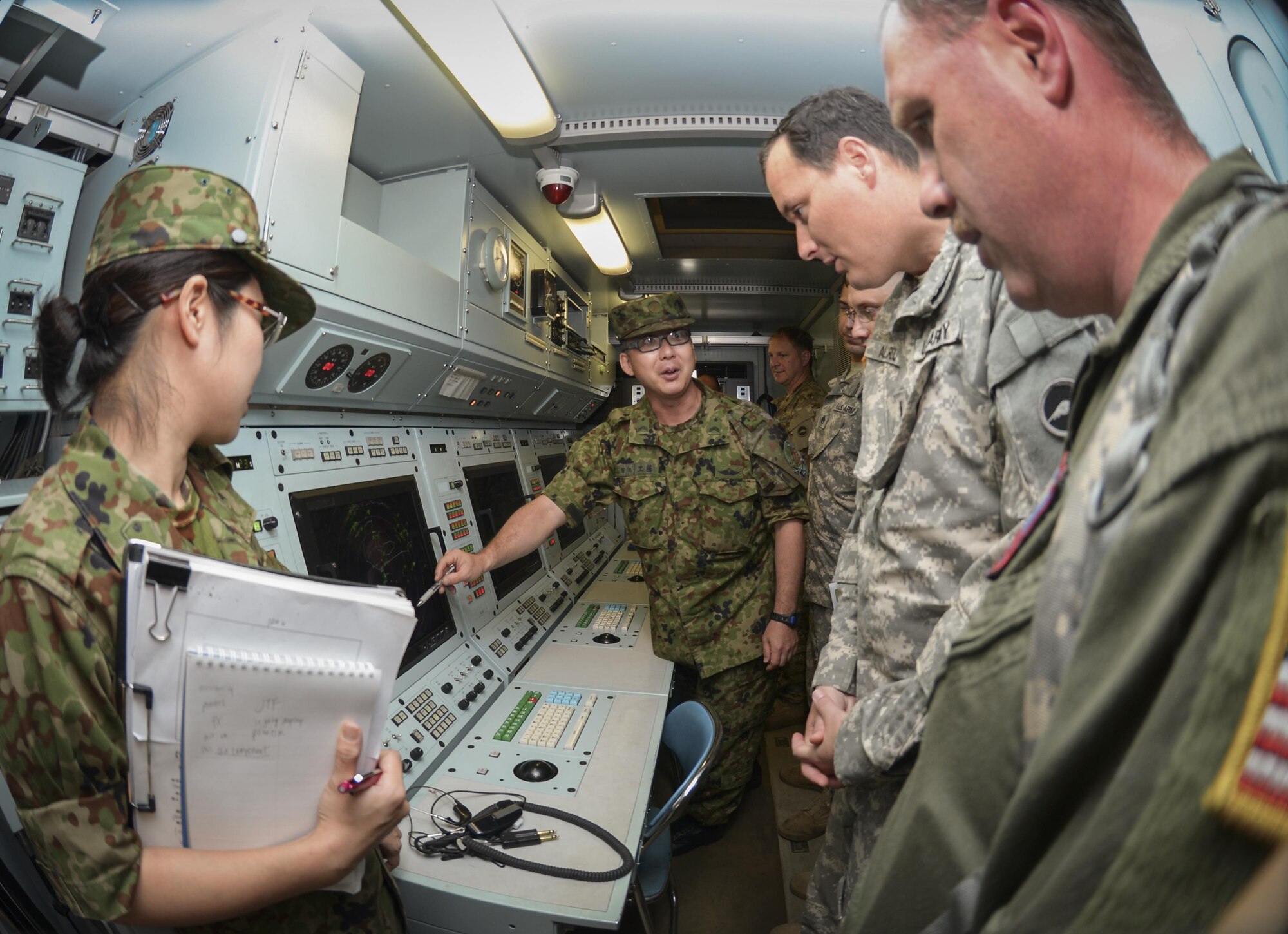 Members of the Japan Ground Self-Defense Force explain the radar display component of the P-20 mobile air traffic control system to members of the U.S Army and Air Force at Camp Tachikawa, July 26, 2016. Members of the JGSDF invited the U.S. Army Aviation Battalion and the 459th Airlift Squadron to attend the 2nd Tachikawa Helicopter Conference, where participants learned about the P-20, part of a new disaster response strategy for helicopters. (U.S. Air Force photo by Airman 1st Class Elizabeth Baker/Released)
