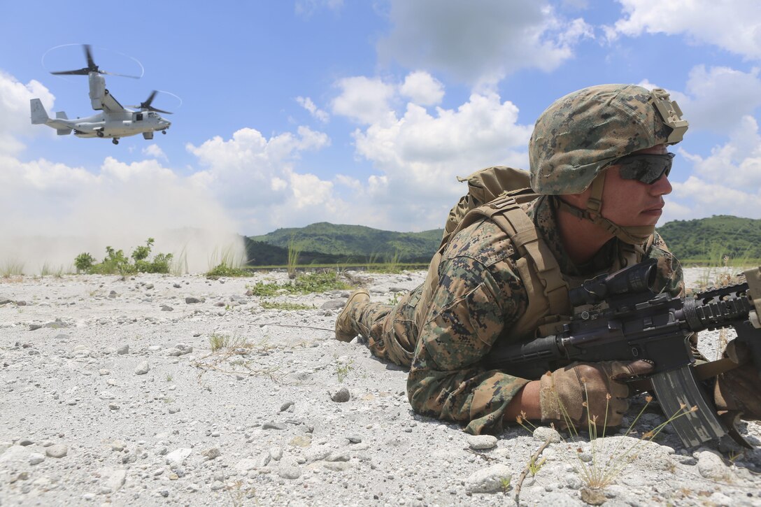 CROW VALLEY, Philippines ─ U.S. Marine Corps Sgt. Manuel Martinez, provides security as an MV-22B Osprey lands at Crow Valley in the Philippines in support of Air Assault Support Exercise 16.2, Aug 4, 2016. The goal of AASE 16.2 is to maintain the readiness and interoperability of the U.S. and Armed Forces of the Philippines to ensure an effective and rapid response to any contingency in the region. Martinez is an infantry squad leader assigned to Lima Company, 3rd Battalion, 3rd Marine Regiment which is currently assigned to 4th Marine Regiment, 3rd Marine Division, III Marine Expeditionary Force, under the unit deployment program. (Marine Corps Photo by Lance Cpl. Carl King/Released)