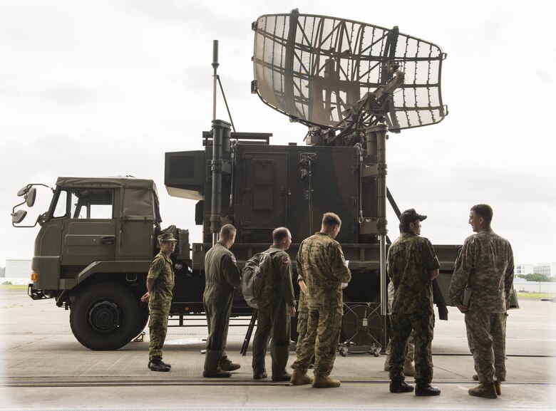 Members of the Japan Ground Self-Defense Force explain the radar detection component of the P-20 mobile air traffic control system to members of the U.S Army and Air Force at Camp Tachikawa, July 26, 2016. The P-20, which takes two hours and six personnel to set up, helps guide search and rescue aircraft and is an important part of rapid disaster-response. (U.S. Air Force photo by Airman 1st Class Elizabeth Baker/Released)