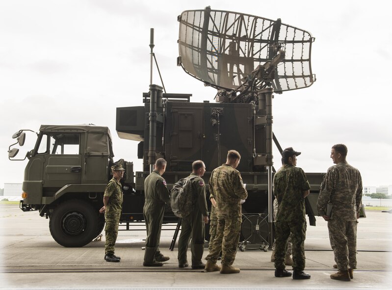 Members of the Japan Ground Self-Defense Force explain the radar detection component of the P-20 mobile air traffic control system to members of the U.S Army and Air Force at Camp Tachikawa, July 26, 2016. The P-20, which takes two hours and six personnel to set up, helps guide search and rescue aircraft and is an important part of rapid disaster-response. (U.S. Air Force photo by Airman 1st Class Elizabeth Baker/Released)