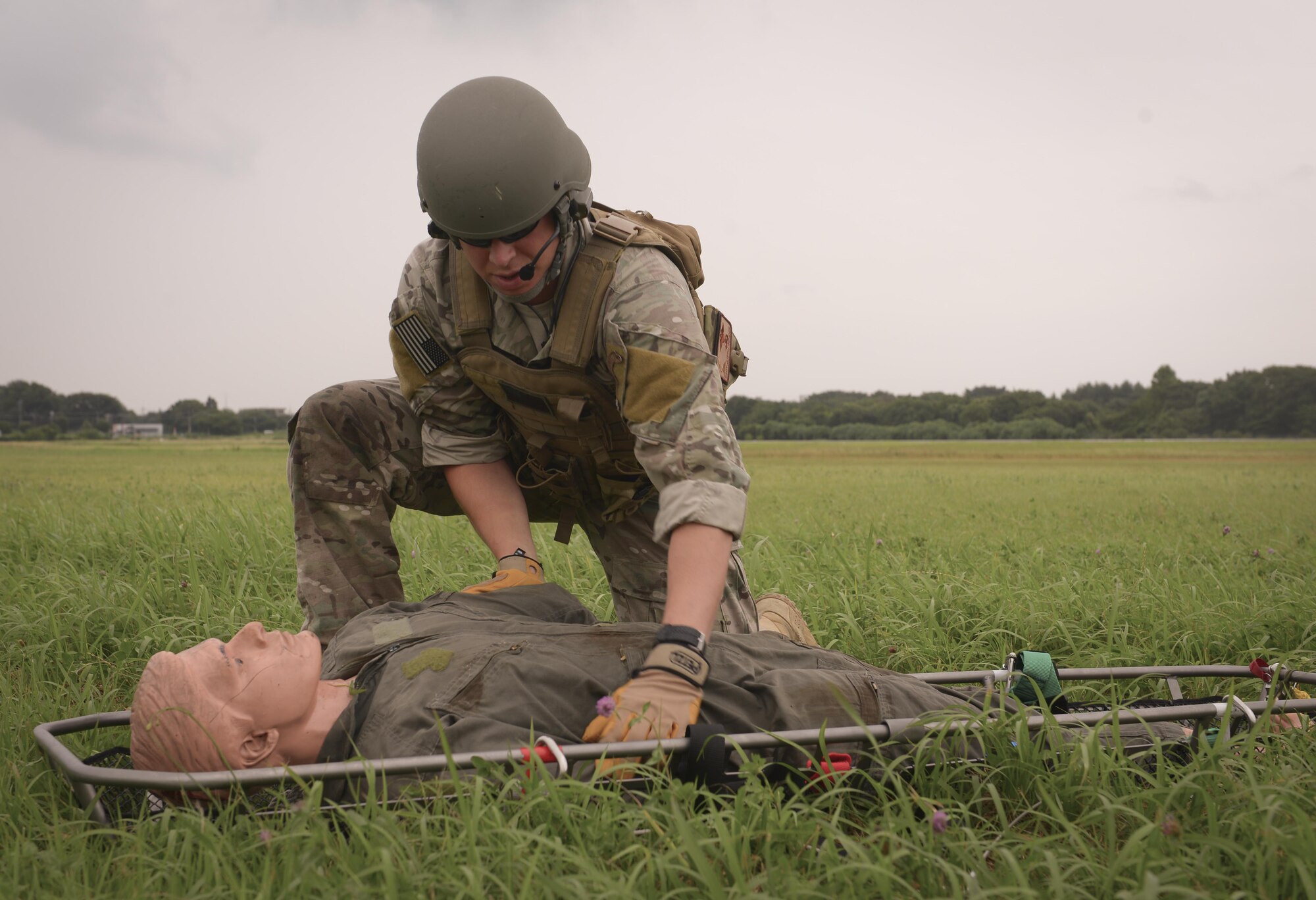 Staff Sgt. Justin Bender, 374th Operations Support Group survival, evasion, resistance and escape specialist, participates in a practice rescue operation at Camp Tachikawa, July 26, 2016. The 459 AS and 374 OSS demonstrated search and rescue capabilities to their Japan Self-Defense Force counterparts, showcasing their tactics and procedures used to support Japan in a disaster-response effort. (U.S. Air Force photo by Airman 1st Class Elizabeth Baker/Released)