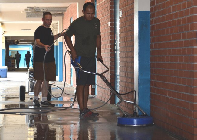 DC1 Joshua Stokes assists MM1 Coronado as he uses a surface cleaner in the hallways at Oak Hill Academy. Stokes and Coronado are Sailors with Southeast Regional Maintenance Center in Mayport, Florida. Both volunteered to help clean, assemble furniture and prepare classrooms for the 2016-2017 school year. The Southeast Regional Maintenance Center (SERMC) is a World Class organization providing surface ship maintenance, modernization and technical expertise in support of the ships of the US Navy, the world’s finest. SERMC also provides visiting vessel services to foreign navies. We provide the highest level of maintenance, repair, technical expertise, training, craftsmanship and professionalism to the ships and sailors of the U.S. Fleet and the SERMC military and civilian workforce.  Photo by Scott Curtis