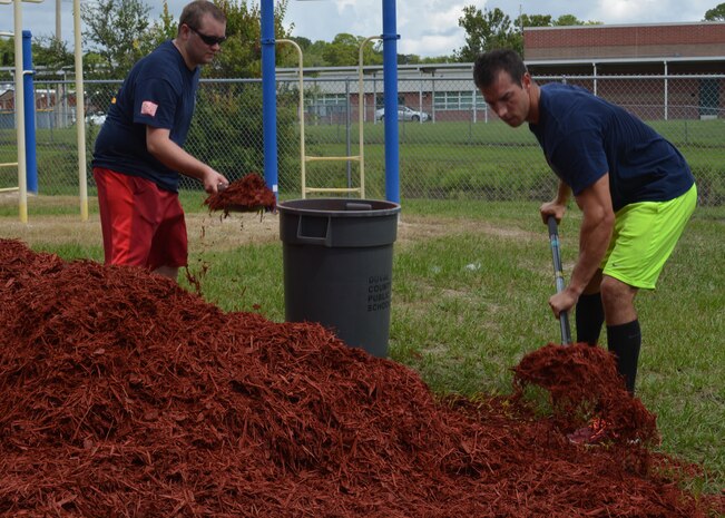 MM1 Brian Hill (R) and EN1 Robin Mosely (L) shovel mulch into a makeshift wheel-barrow at Oak Hill Academy. Hill and Mosely are Sailors with Southeast Regional Maintenance Center in Mayport. Both volunteered to help clean, assemble furniture and prepare classrooms for the 2016-2017 school year. The Southeast Regional Maintenance Center (SERMC) is a World Class organization providing surface ship maintenance, modernization and technical expertise in support of the ships of the US Navy, the world’s finest. SERMC also provides visiting vessel services to foreign navies. We provide the highest level of maintenance, repair, technical expertise, training, craftsmanship and professionalism to the ships and sailors of the U.S. Fleet and the SERMC military and civilian workforce.  Photo by Scott Curtis