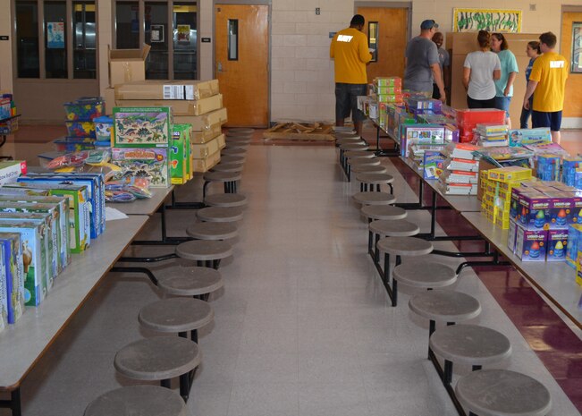 Sailors from Southeast Regional Maintenance Center in Mayport receive instruction from Ms. Angela Bradburry, Board Certified Behavior Analyst at Oak Hill Academy, behind cafeteria tables filled with classroom supplies ready for distribution. All volunteered to help clean, assemble furniture and prepare classrooms for the 2016-2017 school year. The Southeast Regional Maintenance Center (SERMC) is a World Class organization providing surface ship maintenance, modernization and technical expertise in support of the ships of the US Navy, the world’s finest. SERMC also provides visiting vessel services to foreign navies. We provide the highest level of maintenance, repair, technical expertise, training, craftsmanship and professionalism to the ships and sailors of the U.S. Fleet and the SERMC military and civilian workforce.  Photo by Scott Curtis