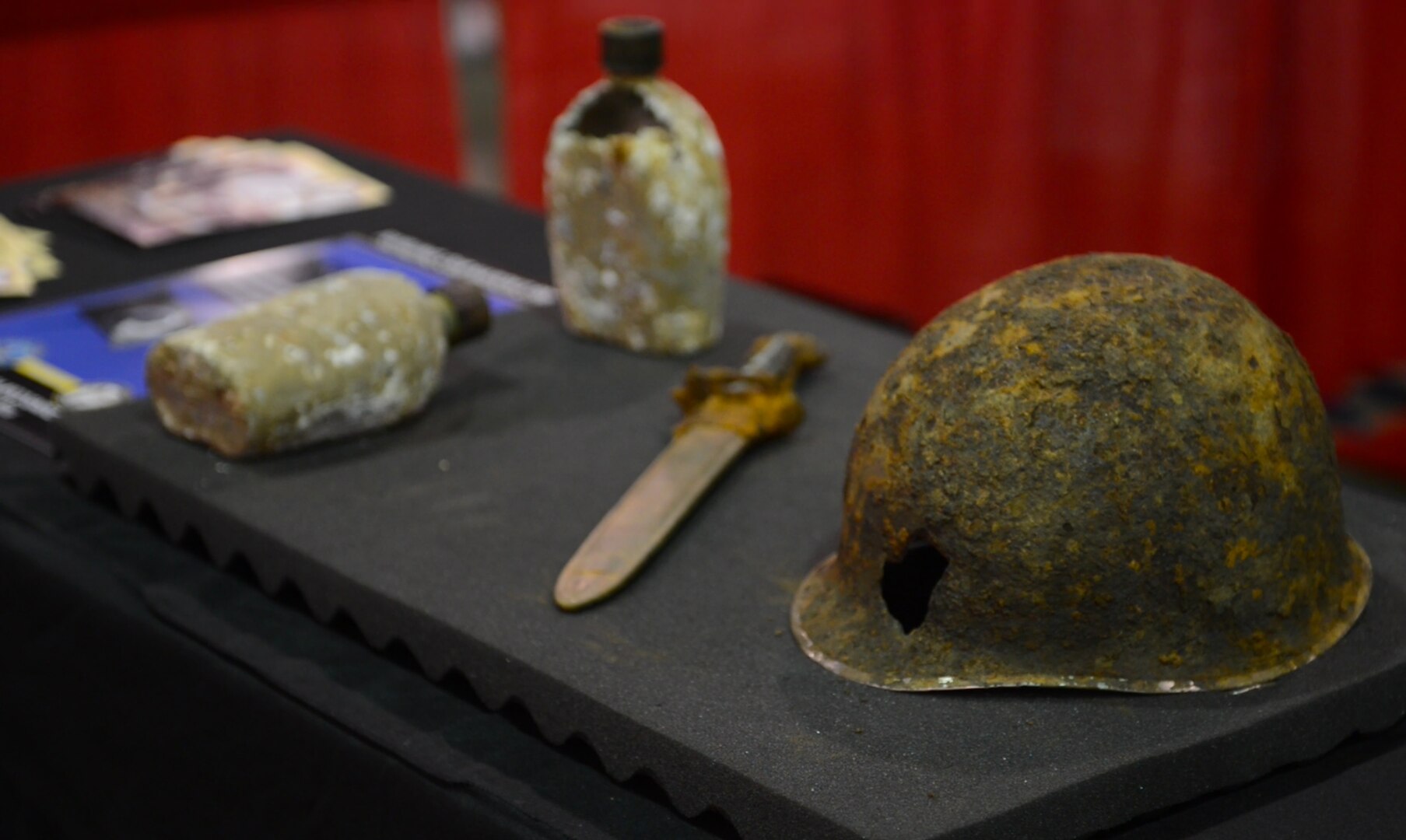 Artifacts from the Korean War are displayed on the Defense POW/MIA accounting agency booth during the Veterans of Foreign Wars Convention held at the Charlotte, North Carolina Convention Center July 23, 2016. The mission of the Defense POW/MIA Accounting Agency is to provide the fullest possible accounting for our missing personnel to their families and the nation. (Photo by U.S. Army Sgt. Tiffany Fudge)