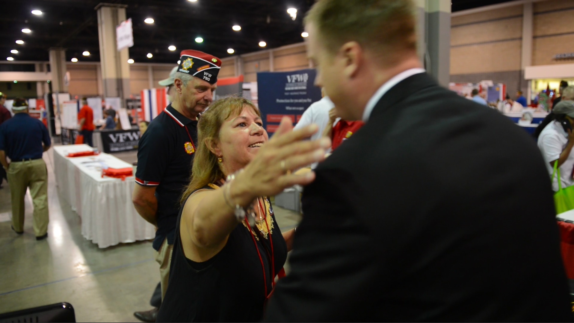 A grateful woman hugs U.S. Navy Lt. Thomas Sloan, a member of the Defense POW/MIA accounting agency (DPAA) at DPAA's booth during the Veterans of Foreign Wars Convention held at the Charlotte, North Carolina Convention Center July 23, 2016. She thanked him for his service and DPAA's mission. The mission of the Defense POW/MIA Accounting Agency is to provide the fullest possible accounting for our missing personnel to their families and the nation. (Photo by U.S. Army Sgt. Tiffany Fudge)