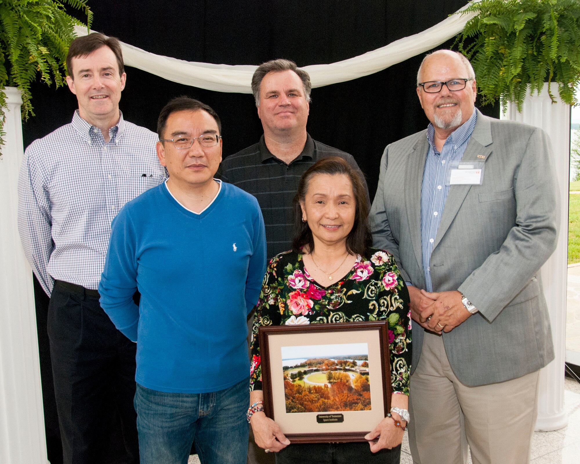 Dr. Them Bui (front row, second from left), a Space Threat Assessment Testbed Control Systems engineer at AEDC, displays the commemorative photo she received during the University of Tennessee Space Institute graduation ceremony May 9, 2016. She was recognized at the ceremony for receiving her doctorate in industrial engineering from the University of Tennessee, Knoxville. Bui is the first recorded female at AEDC to receive a doctorate degree. Pictured with Bui on the front row is Dr. Andrew Yu, associate professor with UTSI. On the back row, left to right, is Dr. Rob McAmis, with AEDC; Dr. Joe Sheeley, with AEDC; and Dr. James Simonton, then interim executive director with UTSI. (Courtesy photo)