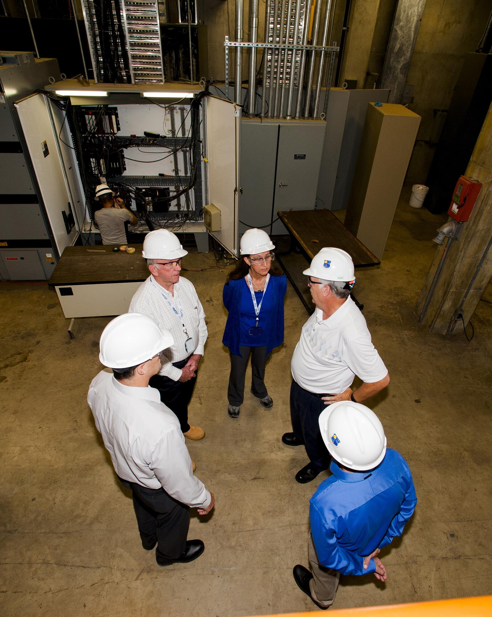 NAS General Manager Cynthia Rivera (center) and NAS Deputy General Manager Doug Pearson (second from left) speak with NAS team members at the Aeropropulsion Systems Test Facility Air Side Plant which provides air to the turbine engine testing facilities. Rivera and Pearson recently visited the facility as part of a “walkthrough” which gave them a chance to see the work performed in that location. Also pictured (far left, clockwise) are team members Rod Cregier, Tim Layton and Mark Chappell. (U.S. Air Force photo/Rick Goodfriend)