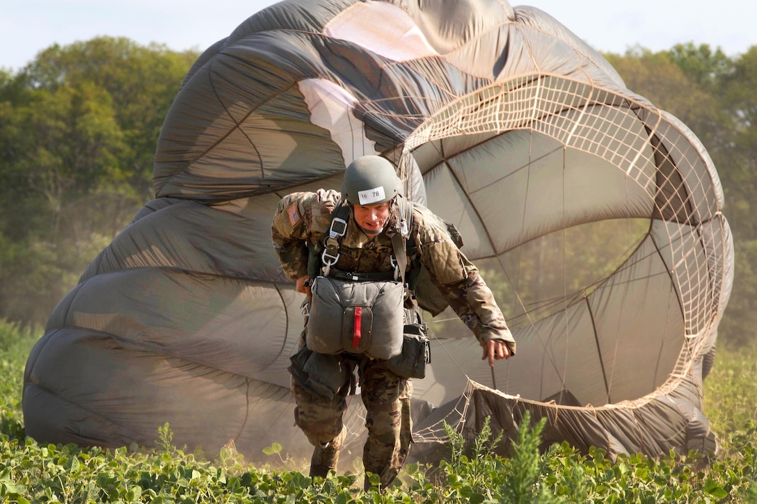 Army Warrant Officer Greg Suchanek drags his parachute toward a rally point during Leapfest 2016, an international parachut training event, in West Kingston, R.I., Aug. 4, 2016. Suchanek is a paratrooper assigned to Special Operations Detachment (NATO). The Rhode Island Army National Guard's 56th Troop Command hosted the event to promote high-level technical training and esprit de corps within the international airborne community. Army photo by Sgt. Brady Pritchett