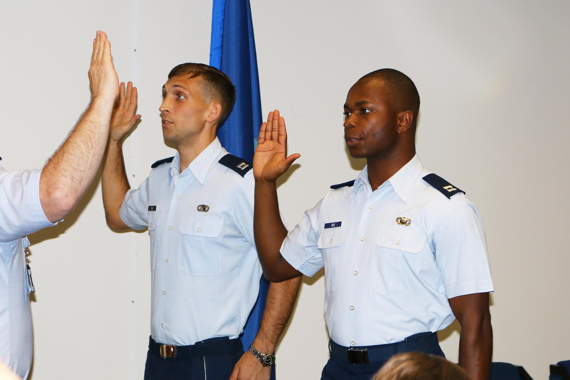 1st Lt. Jonathan Dias and 1st Lt. Hedison Doe take the oath during their promotion ceremony July 8, 2016, at AEDC. Both are being promoted to rank of Captain. The ceremony was led by Col. Timothy West, AEDC Test Operations Division chief, and the families and several friends of Dias and Doe were in attendance. (U.S. Air Force photo/Holly Peterson)