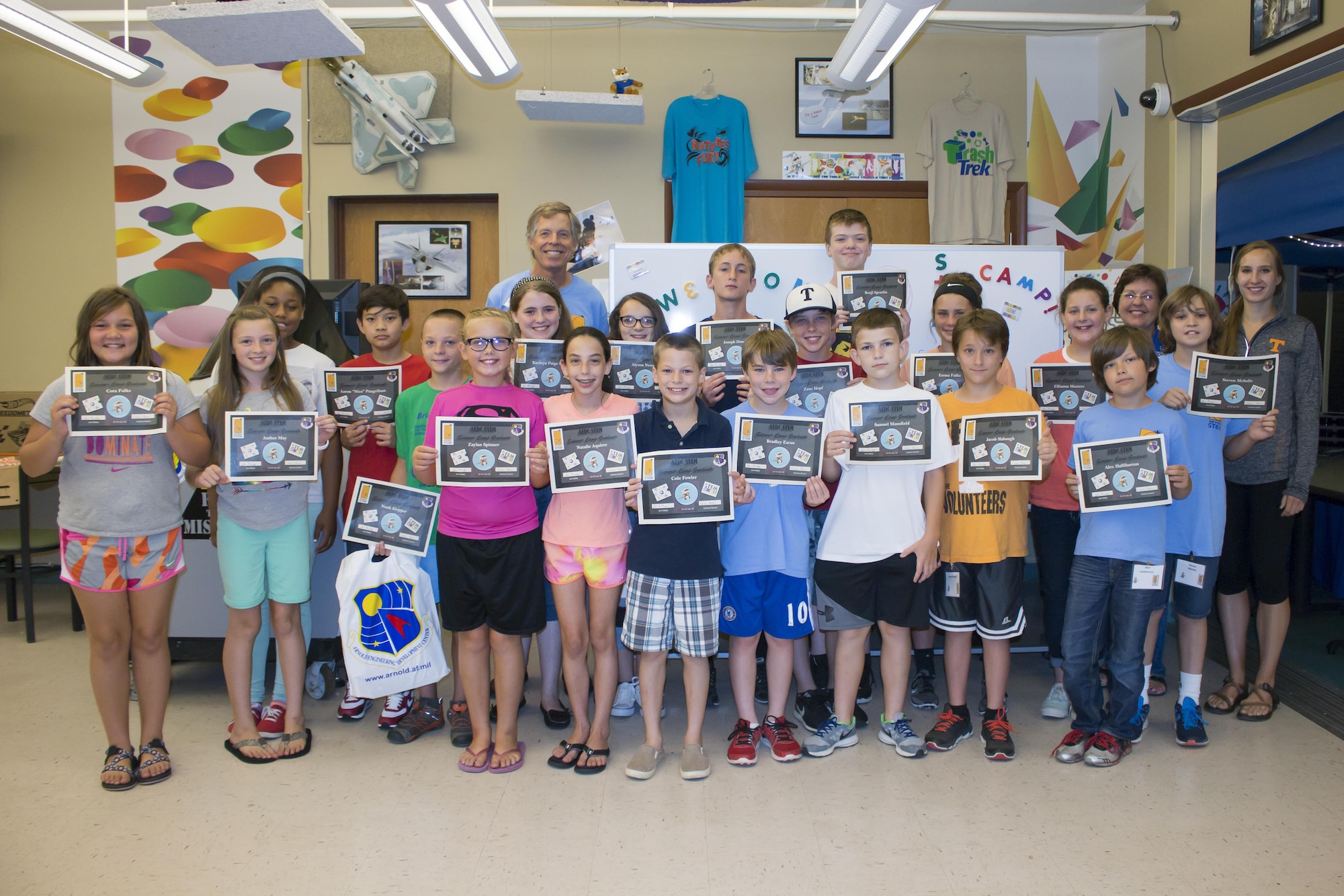 The students in the AEDC Science, Technology, Engineering and Mathematics Camp hold their certificates showing they completed three days of fun, hands-on science activities at AEDC. This year’s STEM Summer Camp was held July 12-14 for children of AEDC employees. Funded through the Air Force Educational Outreach Office, the camp is at no cost to those who attend. A graduation was held at the end of the camp to celebrate the group’s accomplishments. Pictured left to right are the participants in this year’s camp at AEDC; in front: Cora Fulks, Amber May, Zaylan Spinner, Natalie Aquirre, Cole Fowler, Bradley Escue, Samuel Mansfield, Jacob Slabaugh, Alex Halliburton. Second row: Kimberly Coleman, Nico Pangeliman, Noah Klepper, Kathryn Brown, Alyson Newsom, Joseph Duncan, Zane Hopf, Benji Spratlin, Emma Fulks, Ellianna Masters and Steven Mehalic with STEM Camp assistants Carlene Guerin and Laura Burke. In back left is Jere Matty, AEDC STEM outreach specialist. (U.S. Air Force photo/Holly Peterson)