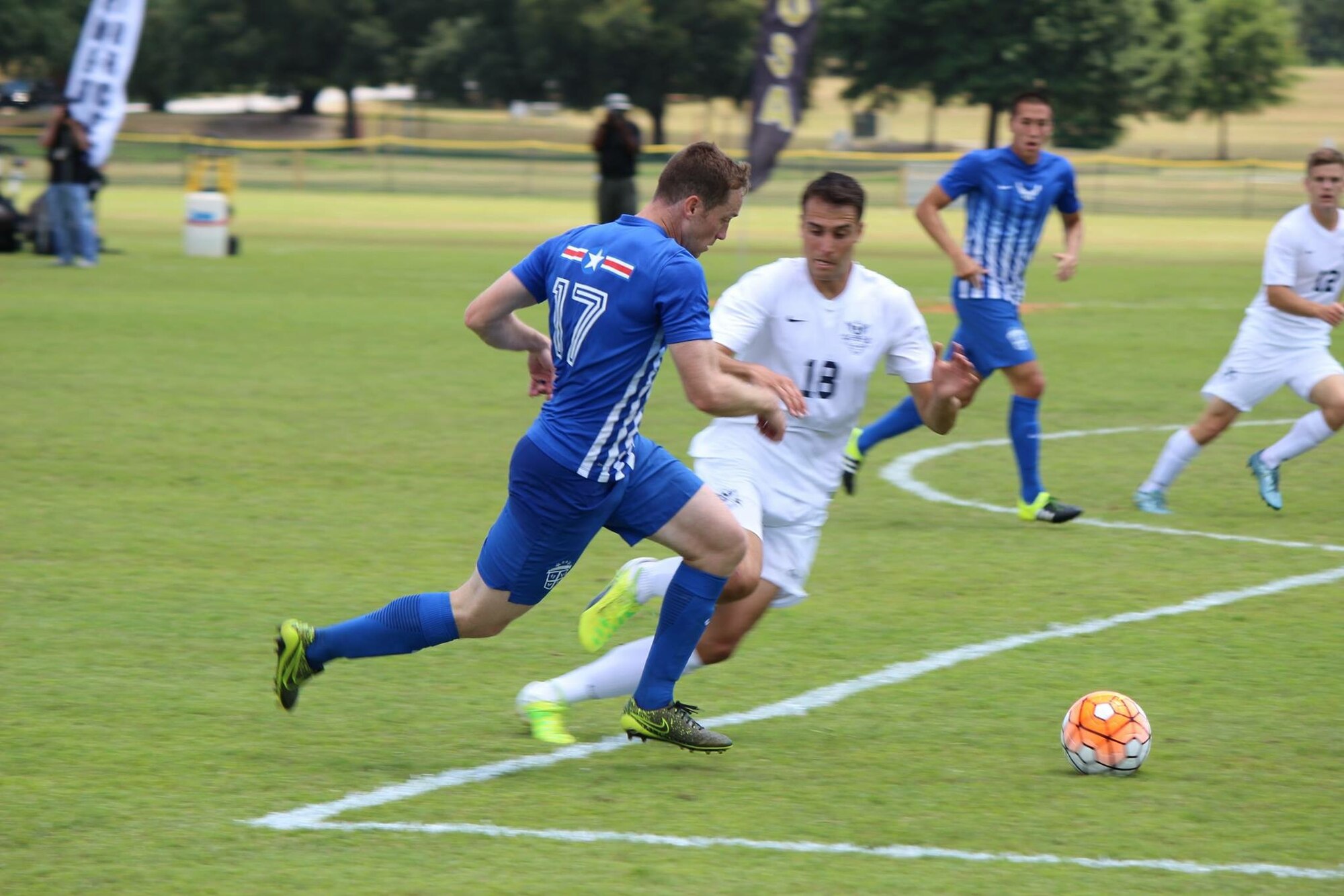 U.S. Air Force 1st Lt. Micah Cummins, number 17, 100th Air Refueling Wing chief of protocol, runs by an All-Navy defender during the finals of the All-Armed Forces Championships May 15, 2016, in Columbus, Georgia. Cummins set up the first goal and scored the second, helping the Air Force defeat the Navy 3-2, bringing home the gold for the Air Force. (Courtesy photo)