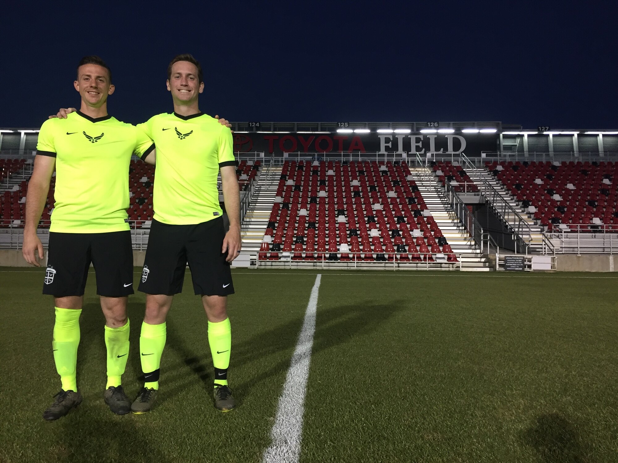 U.S. Air Force 1st Lt. Micah Cummins, right, 100th Air Refueling Wing chief of protocol, poses for a photograph with U.S. Air Force Airman 1st Class Tim Bettes, left, 48th Force Support Squadron Career Development apprentice, after a game against the United Soccer League’s San Antonio Football Club at Toyota Field in San Antonio, Texas, May 4, 2016. Through his love of the sport, Cummins is able to meet many people from across the Air Force. (Courtesy photo)