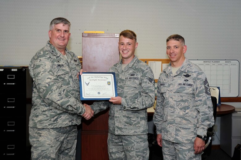 Senior Airman Jonathan Little, 22nd Comptroller Squadron financial analyst, poses with Col. Albert Miller, 22nd Air Refueling Wing commander, and Chief Master Sgt. Shawn Hughes, 22nd ARW command chief, Aug. 1, 2016, at McConnell Air Force Base, Kan. Little received the spotlight performer for the week of June 13-17. (U.S. Air Force photo/Airman 1st Class Jenna Caldwell)