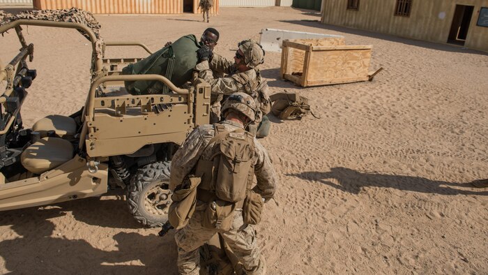 A group of Marines with Kilo Company, 3rd Battalion, 5th Marine Regiment offloading the Polaris MRZR after a mounted patrol throughout the town during the Marine Air Ground Task Force Integrated Experiment 2016 at Marine Corps Air Ground Combat Center Twentynine Palms, Calif.  July 29, 2016. During the exercise Marines had to maintain combat efficiency while sustaining their own food, water, electricity, and security without help from outside forces.