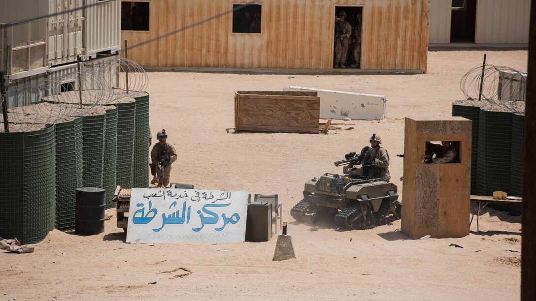 A group of Marines with Kilo Company, 3rd Battalion, 5th Marine Regiment using the Weaponized Multi-utility Tactical Transport to repel an oppositional force attack during the Marine Air Ground Task Force Integrated Experiment 2016 at Marine Corps Air Ground Combat Center Twentynine Palms, Calif.  July 31, 2016. The oppositional force represented a futuristic force that had the capabilities to jam communications, form strategic tactical maneuvers and turn the population against the Marines.