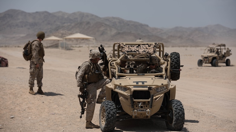 A group of Marines with Kilo Company, 3rd Battalion, 5th Marine Regiment mounting up on the Polaris MRZR after a patrol throughout the town during the Marine Air Ground Task Force Integrated Experiment 2016 at Marine Corps Air Ground Combat Center Twentynine Palms, Calif.  July 31, 2016. The Marines had to go from building to building to ensure that the oppositional force was eliminated before moving on.