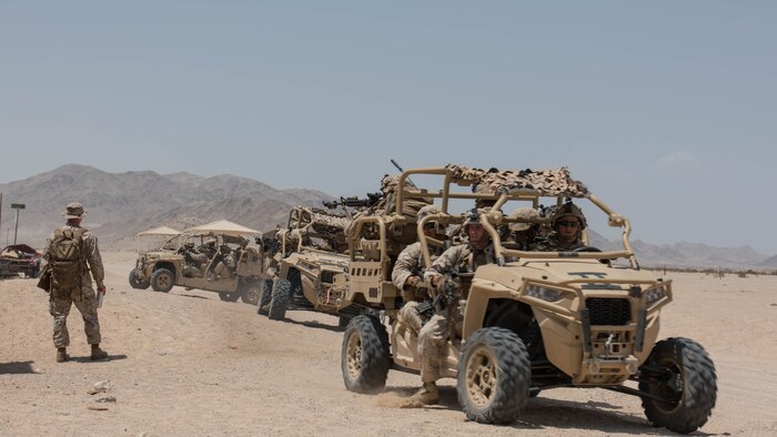 A group of Marines with Kilo Company, 3rd Battalion, 5th Marine Regiment mounting up on the Polaris MRZR after a patrol throughout the town during the Marine Air Ground Task Force Integrated Experiment 2016 at Marine Corps Air Ground Combat Center Twentynine Palms, Calif.  July 31, 2016. The Marines had to go from building to building to ensure that the oppositional force was eliminated before moving on.