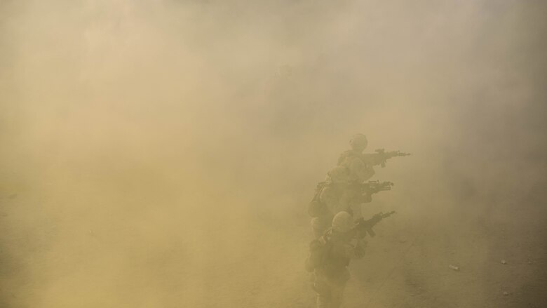 A group of Marines with Kilo Company, 3rd Battalion, 5th Marine Regiment attacking the oppositional force headquarters through a field of smoke during the Marine Air Ground Task Force Integrated Experiment 2016 at Marine Corps Air Ground Combat Center Twentynine Palms, Calif. as part of the final course of action for the exercise.  July 31, 2016. The Marines used everything they learn throughout the course of the exercise to secure the enemy headquarters.