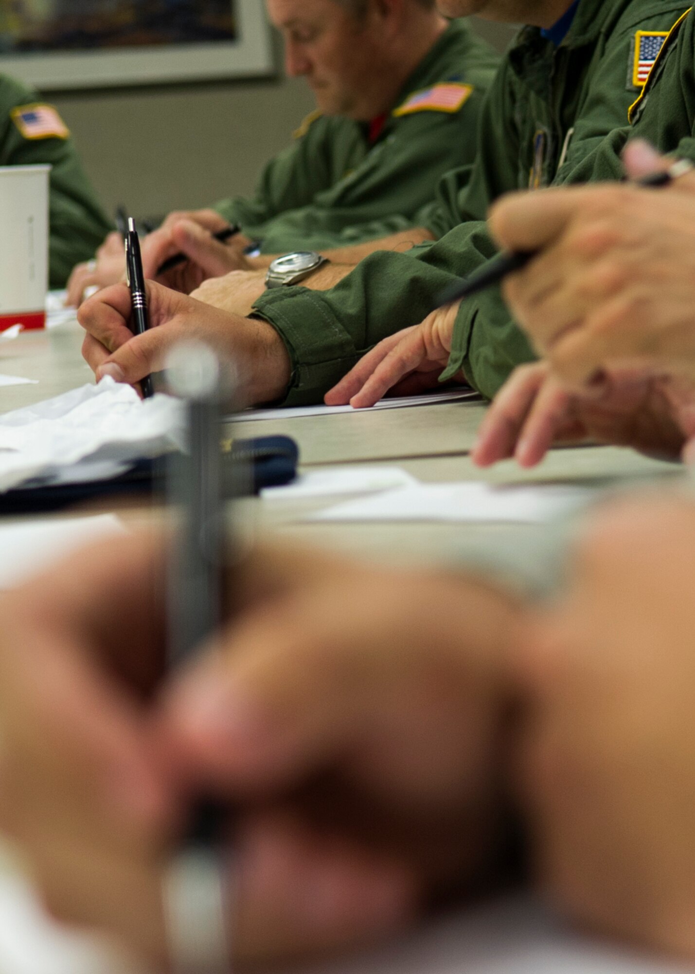 Airmen write potential barriers to intervene after hearing a simulated scenario involving interpersonal violence during Green Dot training Aug. 6, 2016 at Grissom Air Reserve Base, Ind. Nearly 100 Airmen attended mandatory Green Dot training as part of a five-year strategy to decrease interpersonal violence across the total Air Force Aug. 6-7. (U.S. Air Force photo/Staff Sgt. Katrina Heikkinen)  