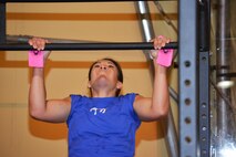 Ana Shockey, 50th Space Wing team member, performs a pull-up as part of the Murph competition during the Tri-Wing Sports Day at Schriever Air Force Base, Colorado, Friday, Aug. 5, 2016. Shockey was part of a 5-person team which earned second-place in the event, helping the 50th Space Wing win the Tri-Wing trophy. (U.S. Air Force photo/Brian Hagberg)