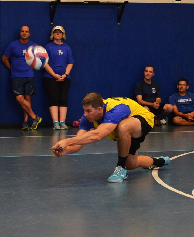 Seth Miller, 50th Space Wing, digs the ball during the volleyball portion of the Tri-Wing Sports Day at Schriever Air Force Base, Colorado, Friday, Aug. 5, 2016. The 50th Space Wing’s 2-0 record in volleyball helped earn the wing the Tri-Wing trophy. (U.S. Air Force photo/Brian Hagberg)