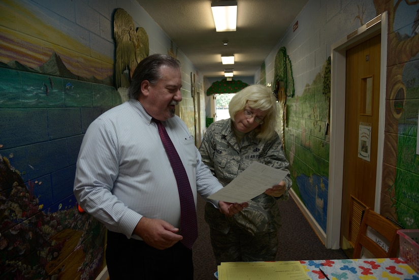 U.S. Air Force Master Sgt. Amy Lynch, Heritage of America Band regional band craftsman and Gerald J. Patesel, Peninsula Agency of Aging director of community services, look over her scheduled route for her weekly “Meals on Wheels” delivery at Hampton, Va., on July 28, 2016. “Meals on Wheels” is a home-delivered meals program geared toward promoting better health in home-bound senior citizens.(U.S. Air Force photo by Tetaun Moffett)