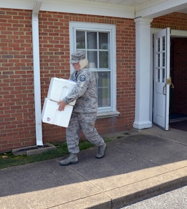 U.S. Air Force Master Sgt. Amy Lynch, Heritage of America Band regional band craftsman takes her assigned meals to her vehicle for her weekly “Meals on Wheels” delivery at Hampton, Va., on July 28, 2016. Joint Base Langley-Eustis volunteers are responsible for delivering meals to 32 of 280 homes in the Hampton Roads community.(U.S. Air Force photo by Tetaun Moffett)