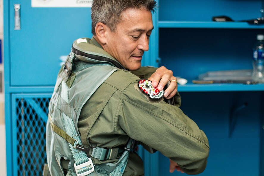 Maj. Gen. Michael Kim, mobilization assistant to Air Force Reserve commander, puts on a 457th Fighter Squadron patch as he prepares for his F-16 Fighting Falcon flight Aug. 8, 2016, at Naval Air Station Fort Worth Joint Reserve Base, Texas.