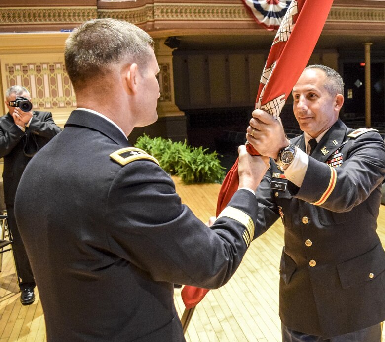 In a traditional act that is rooted in military history dating back to the 18th century, Maj. Gen. Donald E. (Ed) Jackson, Jr., passed the command flag to Col. John P. Lloyd to symbolize the transfer of responsibility from one commander to another.