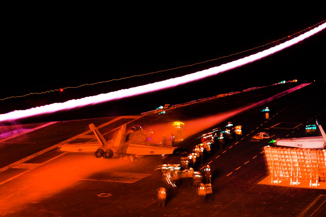 Sailors prepare to launch a Navy F/A-18E Super Hornet assigned to Strike Fighter Squadron 137 from the flight deck of the aircraft carrier USS Carl Vinson as another F/A-18E launches during night operations in the Pacific Ocean, Aug. 4, 2016. Navy photo by Seaman Daniel P. Jackson Norgart