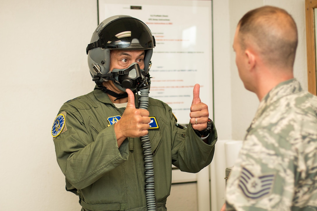 Maj. Gen. Michael Kim, mobilization assistant to the Air Force Reserve Command commander, provides thumbs up to Technical Sgt. Rudy Panacci, NCOIC, aircrew flight equipment, during preliminary fitting of helmet and mask prior to his incentive flight here Aug. 8, 2016.