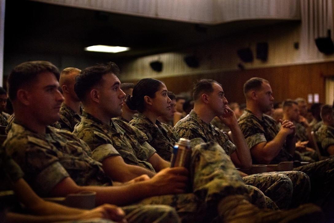 Marines with 8th Communication Battalion, listen to a personal story regarding suicide during a special readiness evolution at Camp Lejeune, N.C., August 3, 2016. Navy Lt. Cmdr. David L. Duprey, a chaplain with the Marine Raider Support Group, spoke to  the Marines  about his experience with the loss of a loved one due to suicide and how it lead him to do what he does as a chaplain. The brief focused on building support between members of a unit and maintaining operational readiness. (U.S. Marine Corps photo by Pfc. Juan Soto-Delgado)