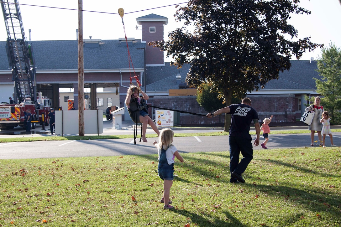 Children have fun racing down a zip line during Defense Distribution Center Susquehanna’s National Night Out on Aug. 2.